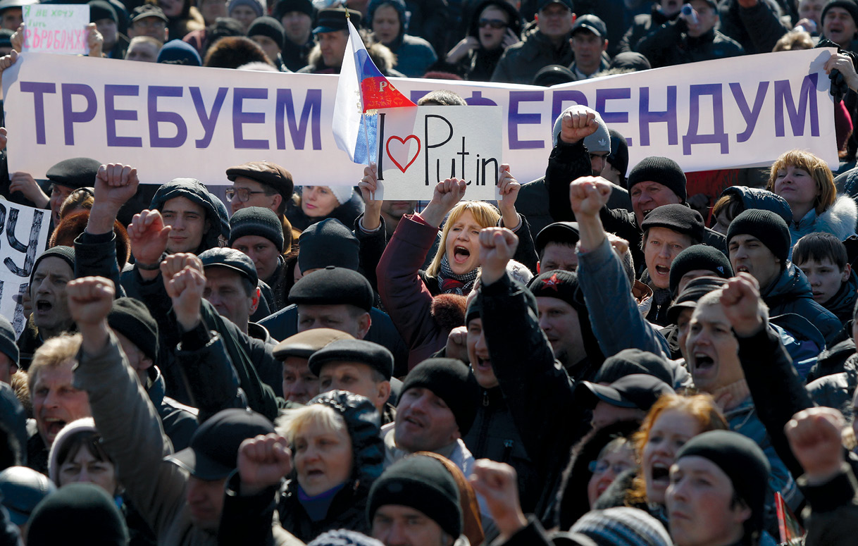 People hold a banner reading “We demand a referendum” as they shout slogans during a pro-Russian rally 8 March 2014 in Donetsk, Ukraine, and as Russia was reported to be reinforcing its military presence in Crimea. (Photo by Sergei Grits, Associated Press) 