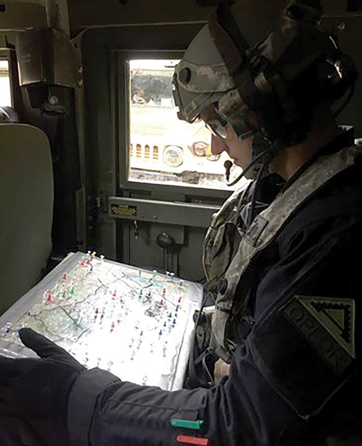 Intelligence officer, reviews his current analog enemy situational template after a battle in  exercise Combine Resolve