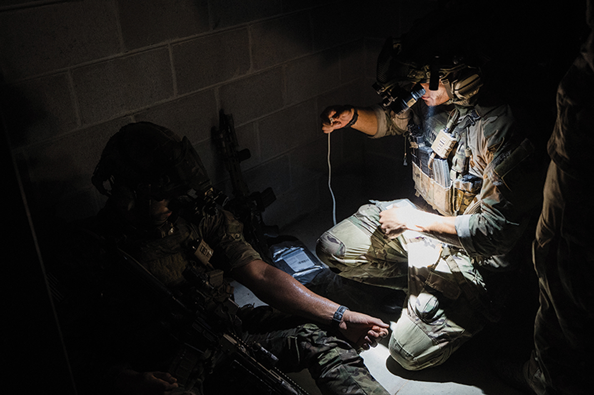 A ranger assigned to the 75th Ranger Regiment performs medical lifesaving procedures