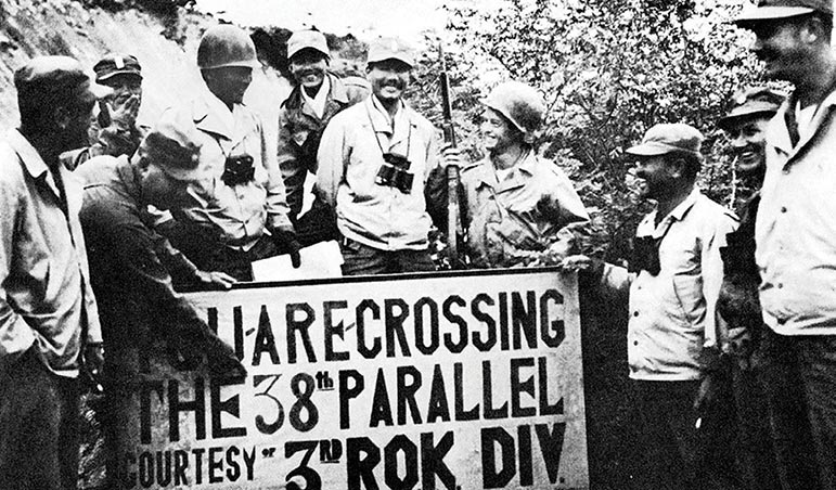 Members of a UN public health and welfare detachment, a composite allied force, meet at a crossing point on the 38th parallel