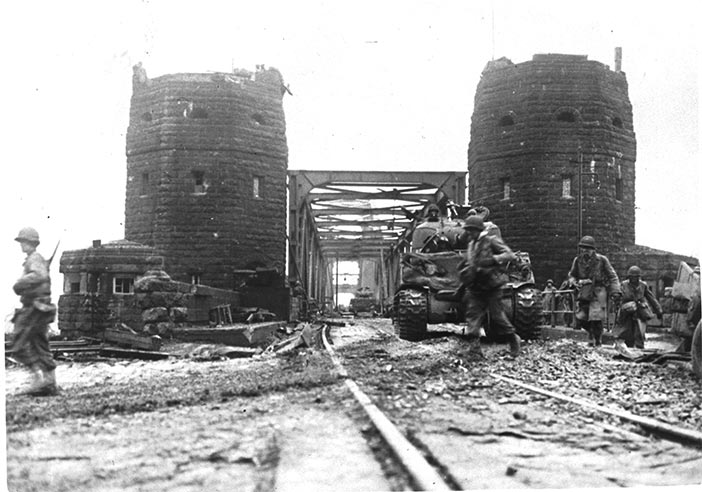 U.S. tanks cross the Ludendorff Bridge 7 March 1945 at Remagen, Germany.