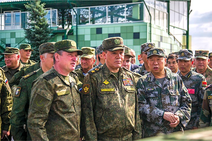 Lt. Gen. Alexander Lapin, commander of Russia’s Central Military District (<i>left</i>), Valery Gerasimov, Russia’s first deputy defense minister and chief of the general staff of the Russian armed forces (<i>second from left</i>), and other Shanghai Cooperation Organization leaders observe training during Peace Mission 2018 at Chebarkulsky Training Ground, Chelyabinsk Region, Russia.