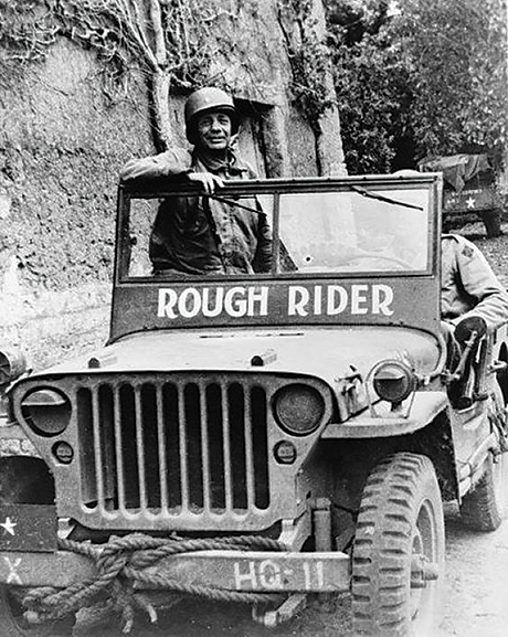 In his jeep, “Rough Rider,” Brig. Gen. Theodore Roosevelt Jr. moves with frontline troops 6 June 1944 away from Utah Beach in Normandy, France.