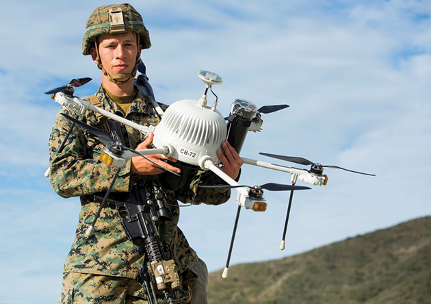 A Marine with Kilo Company, 3rd Battalion, 4th Marine Regiment, poses with a drone during Urban Advanced Naval Technology Exercise 2018 at Camp Pendleton, California