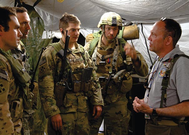 Carl Siebentritt from the Department of State (right) mentors civil affairs soldiers during an exercise in 2016.