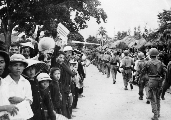 Impressed by civic action deeds, central Vietnam villagers who had been under Viet Minh control for nine years welcome Vietnamese army troops in 1955.