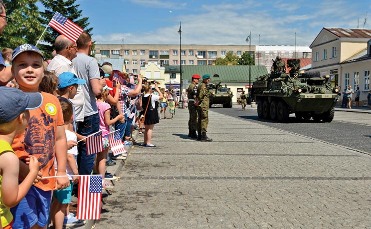 >Soldiers of 4th Squadron, 2nd Calvary Regiment drive Stryker combat vehicles through the main square of Suwalki, Poland