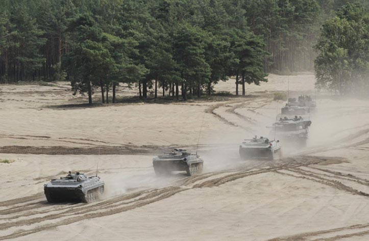 Polish tank crews assigned to the 11th Lubuska Armoured Cavalry Division roll into position to provide supporting fire to soldiers of the 3rd Combined Arms Battalion, 69th Armor Regiment, 3rd Infantry Division