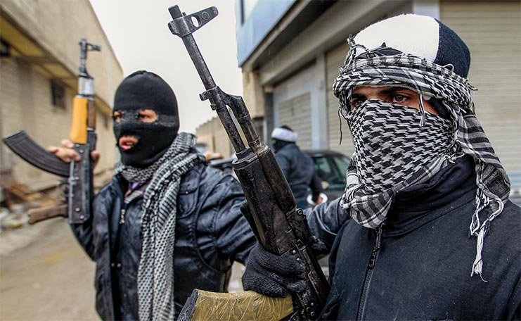 Syrian soldiers who have defected to join the Free Syrian Army secure a street 27 January 2012 in Saqba