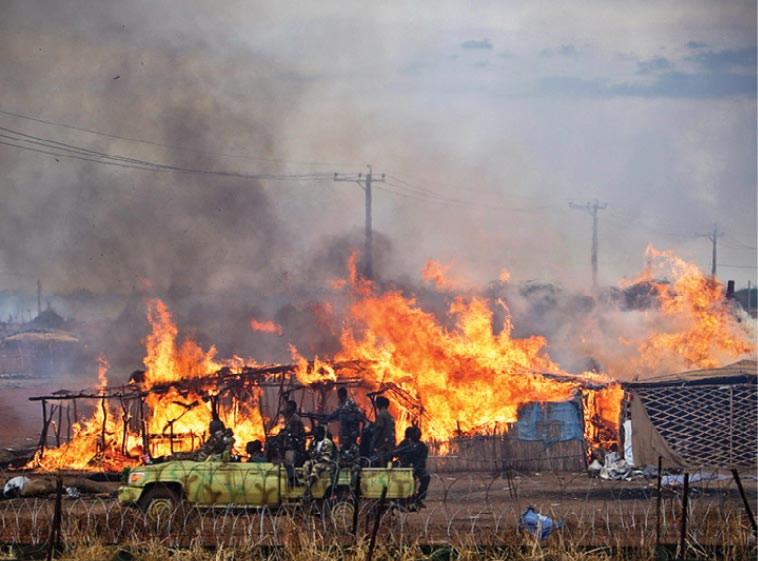 Soldiers are accused of burning huts in the disputed town of Abyei, the scene of renewed violence after Sudanese government forces took over