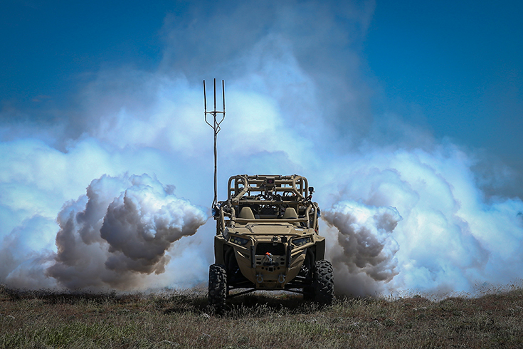 An autonomously activated device emits vapor to obscure the rear of a utility task vehicle 26