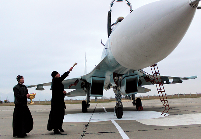 Priest-blesses-fighter-jet.jpgDragonStock.png