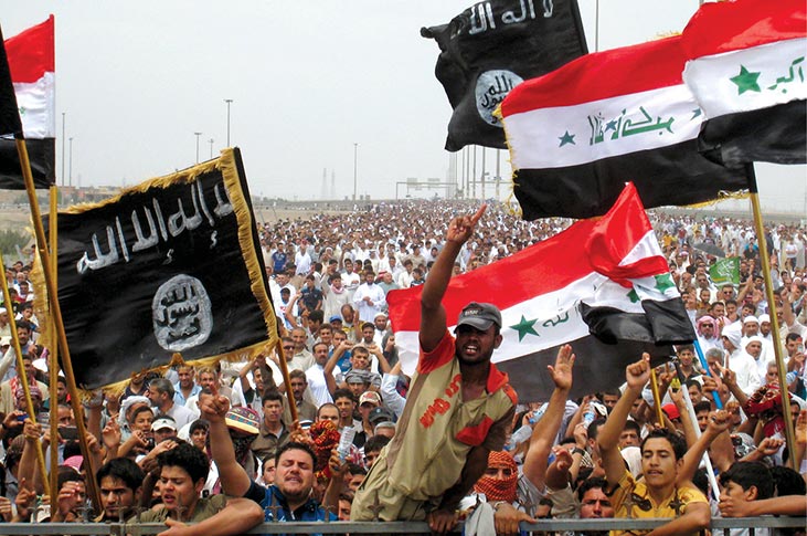 Sunni protesters wave Islamist flags and chant slogans 3 May 2013 at an antigovernment rally in Fallujah