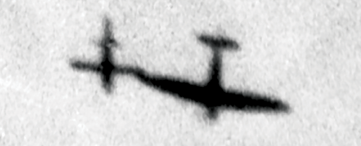 A photo of shadows on the ground show a Royal Air Force Supermarine Spitfire maneuvres alongside a German V-1 flying bomb 31 December 1943 in an attempt to “topple” or deflect it from its target. (Photo courtesy of The Imperial War Museums)