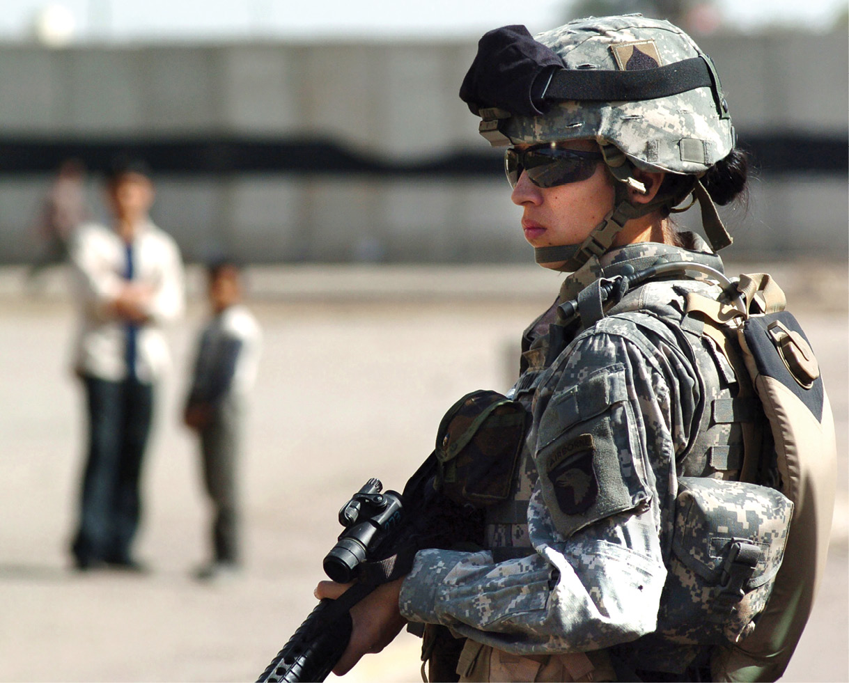 Pfc. Brandie Leon, 4th Infantry Division, pulls security 3 March 2006 while on patrol in east Baghdad to help maintain peace after attacks on mosques in the area. (Photo by Staff Sgt. Jason Ragucci, U.S. Army)