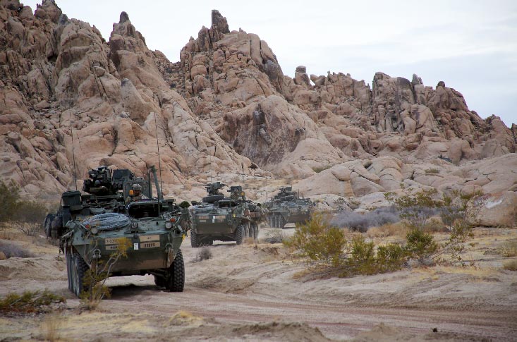 Soldiers in Stryker armored vehicles assigned to 2nd Battalion, 23rd Infantry Regiment, 1st Stryker Brigade Combat Team, 4th Infantry Division