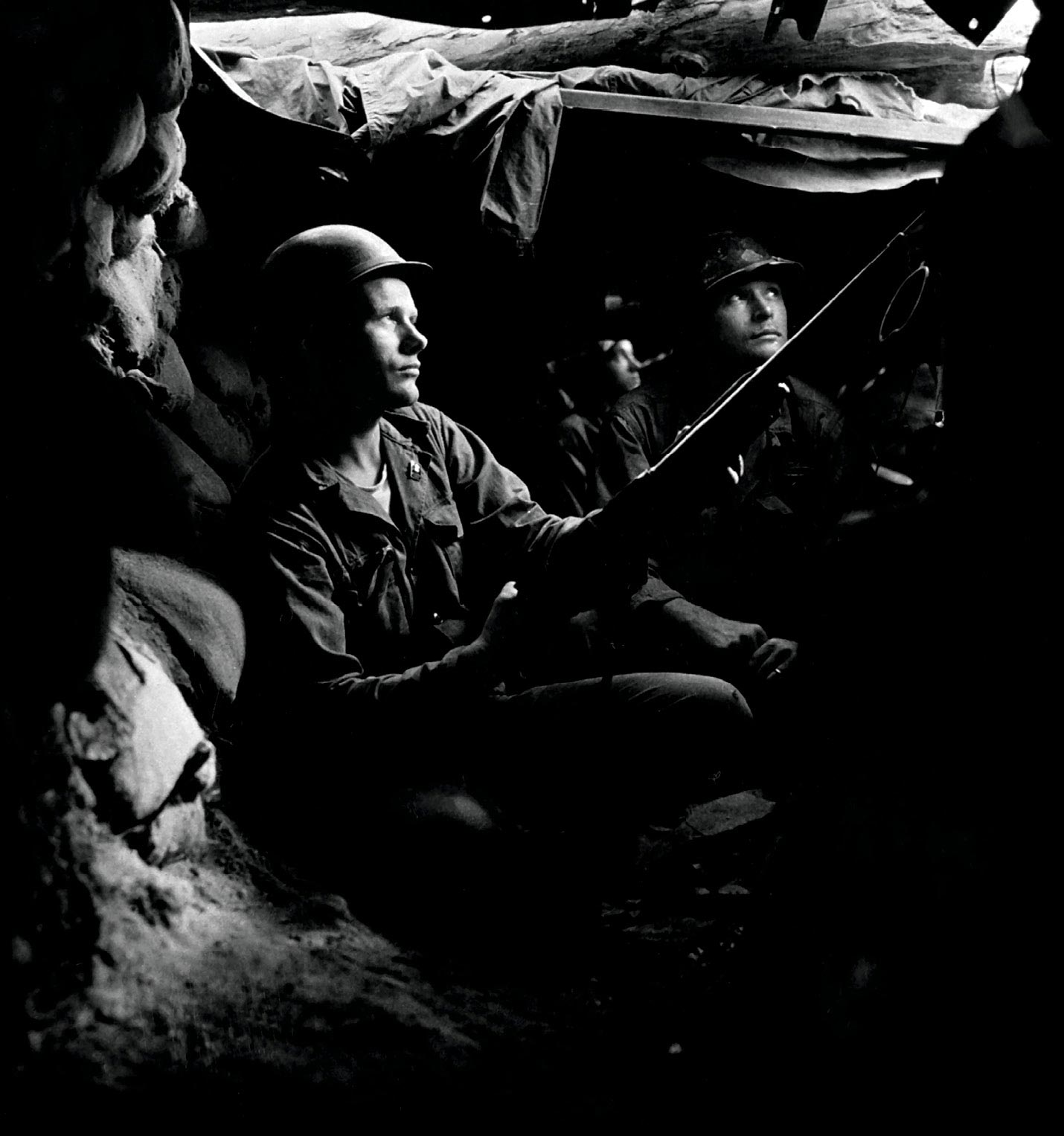 Infantrymen of the 27th Infantry Regiment take advantage of cover and concealment in tunnel positions 10 August 1952, forty yards from the communists near Heartbreak Ridge in North Korea.