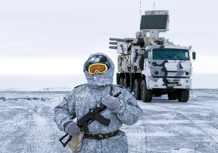 A Russian soldier stands guard by a Pansyr-S1 air defense system 3 April 2019 on Kotelny Island, part of the New Siberian Islands archipelago