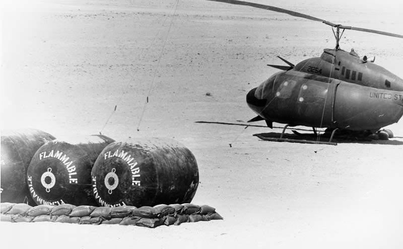 An inflatable OH-58C Kiowa helicopter and inflatable fuel blivets simulate a forward arming and refueling point