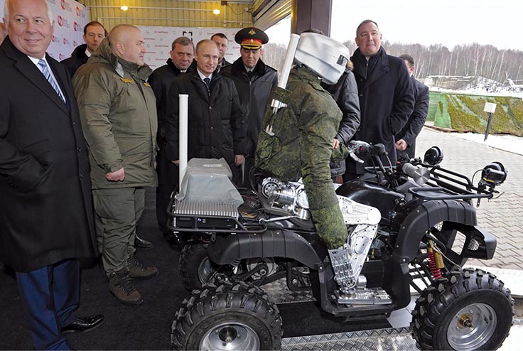 Russian president Vladimir Putin is shown a combat robot 20 January 2015 during his visit to the Central Scientific Research Institute of Precise Mechanical Engineering in Klimovsk