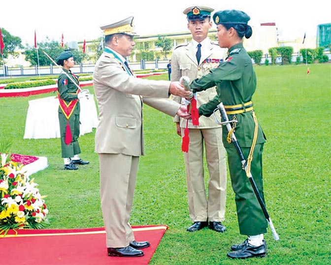 Senior Gen. Min Aung Hlaing (<em>left</em>), commander-in-chief of the defense services, attends a graduation ceremony August 2014 for the nearly one hundred female cadets graduating from the Defense Services Academy in Myanmar