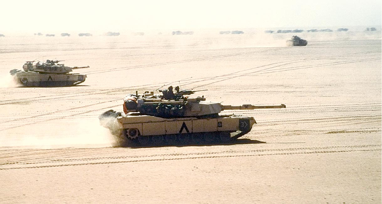 M1A1 Abrams main battle tanks of the 3rd Armored Division move out on a mission 15 February 1991 during Operation Desert Storm.