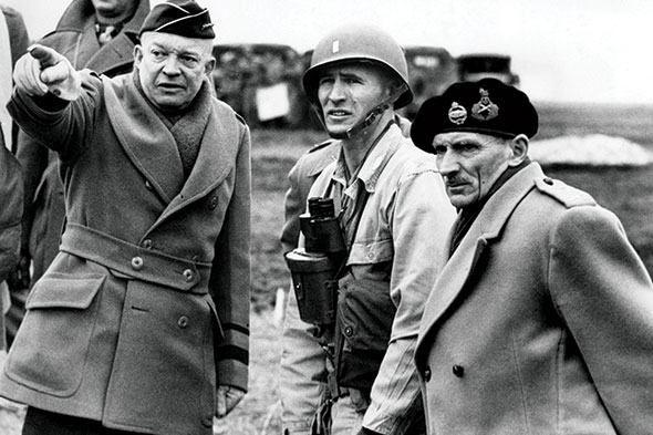 Gen. Dwight D. Eisenhower (left) and Britain’s Field Marshall Bernard Montgomery (far right) confer with a junior U.S. Army officer on the progress of tank maneuvers in England 25 February 1944 in preparation for the invasion of Normandy in June 1944. (Photo from the Everett Collection via Alamy Stock Photo)