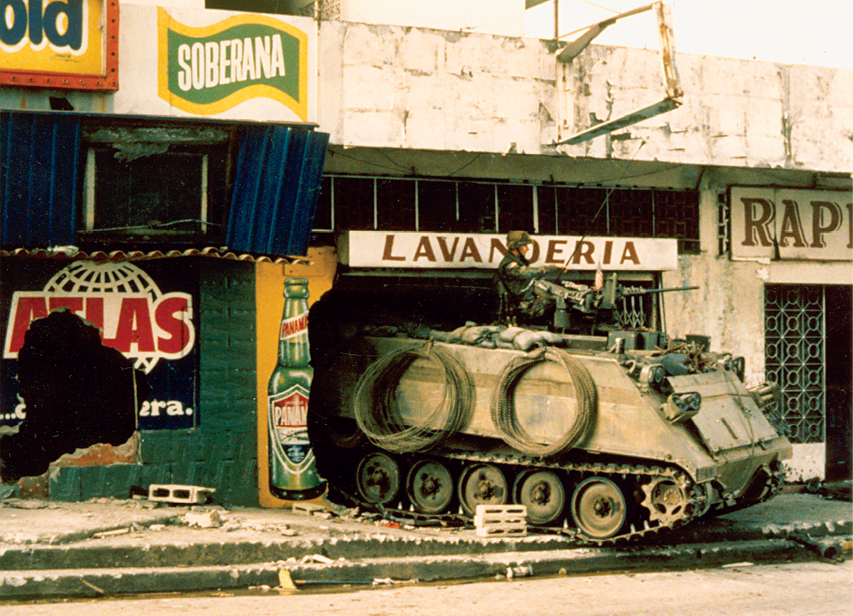 A U.S. M-113 armored personnel carrier finds shelter in a laundromat December 1989 during Operation Just Cause in Panama City. Heavy (armored) forces provided firepower, protection, and mobility during combat and were critical to the success of the operation in Panama's urban terrain. (Photo courtesy of the Maxwell Thurman Photograph Collection at the U.S. Army Center Of Military History)