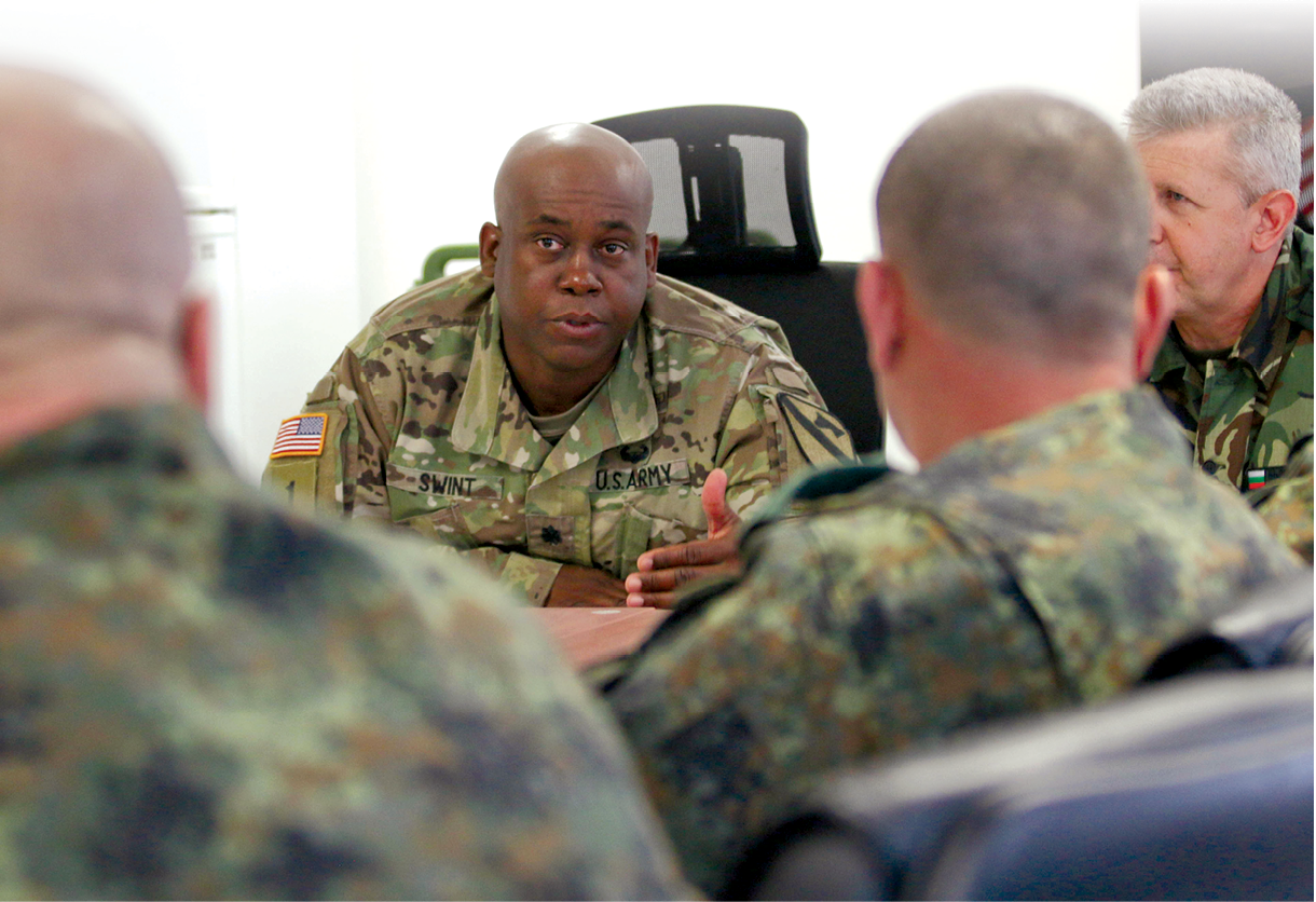 Lt. Col. Kelvin Swint, commander of 2nd Battalion, 5th Cavalry Regiment, 1st Armored Brigade Combat Team, 1st Cavalry Division, negotiates details of future combined training exercises with European partners 26 July 2018 during a bilateral training conference in support of Atlantic Resolve, Novo Selo Training Area, Bulgaria. (Photo by Sgt. Jamar Marcel Pugh, U.S. Army National Guard)