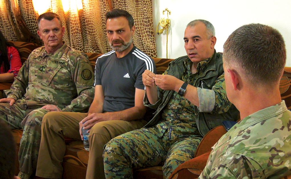 Gen. Chiya (second from right), commander of the Syrian Democratic Forces in Syria’s Middle Euphrates River Valley (MERV), discusses the elimination of Islamic State combatants in the MERV 11 July 2018 during a meeting with U.S. Army Lt. Gen. Paul E. Funk (left), commander of the Combined Joint Task Force–Operation Inherent Resolve and U.S. Army Maj. Gen. James B. Jarrard (right), commander of Special Operations Joint Task Force–Operation Inherent Resolve in Syria. The authors recommend educating Army leaders on negotiation with multinational partners at all levels of their professional military education. (Photo by Sgt. Brigitte Morgan, U.S. Army)