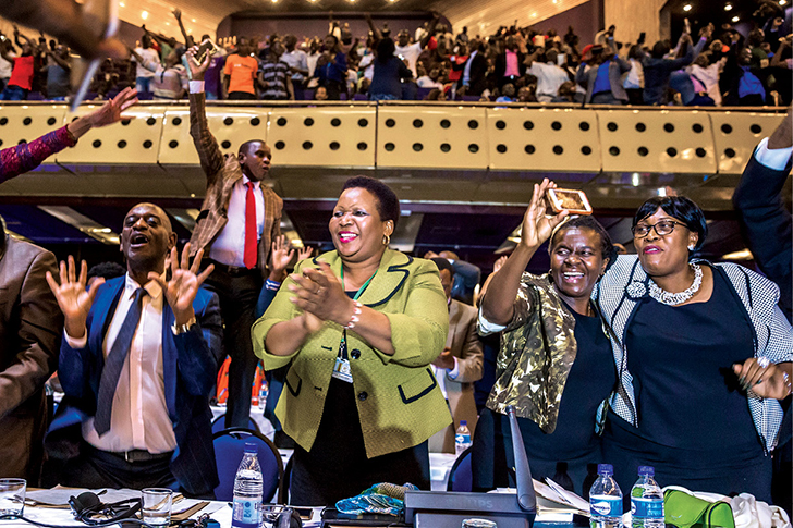 Members of parliament celebrate 21 November 2017 after President Robert Mugabe’s resignation in Harare, Zimbabwe. Mugabe was swept from power as his thirty-seven-year reign of brutality and autocratic control crumbled within days of a military takeover. The bombshell news was delivered by the parliament speaker to a special joint session of the assembly that had convened to impeach Mugabe, who had dominated every aspect of Zimbabwean public life since the country’s independence in 1980. (Photo by Jekesai Njikizana, Agence France-Presse)