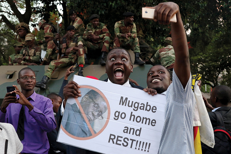 Zimbabweans celebrate 18 November 2017 after President Robert Mugabe resigned in Harare, Zimbabwe.