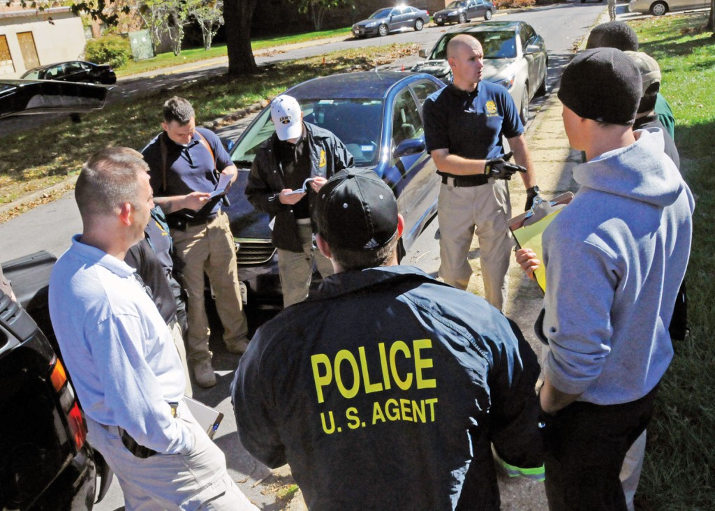 Marlow (center, pointing) discusses the training scenarios with members of the Washington CID Battalion in October. (Photo by Michael L. Lewis)