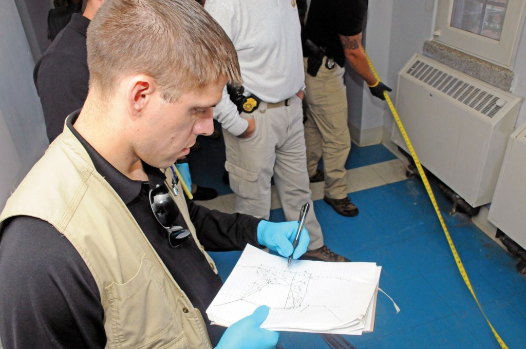 Barnes records and sketches the precise measurements of the location of a mock victim. (Photo by Michael L. Lewis)