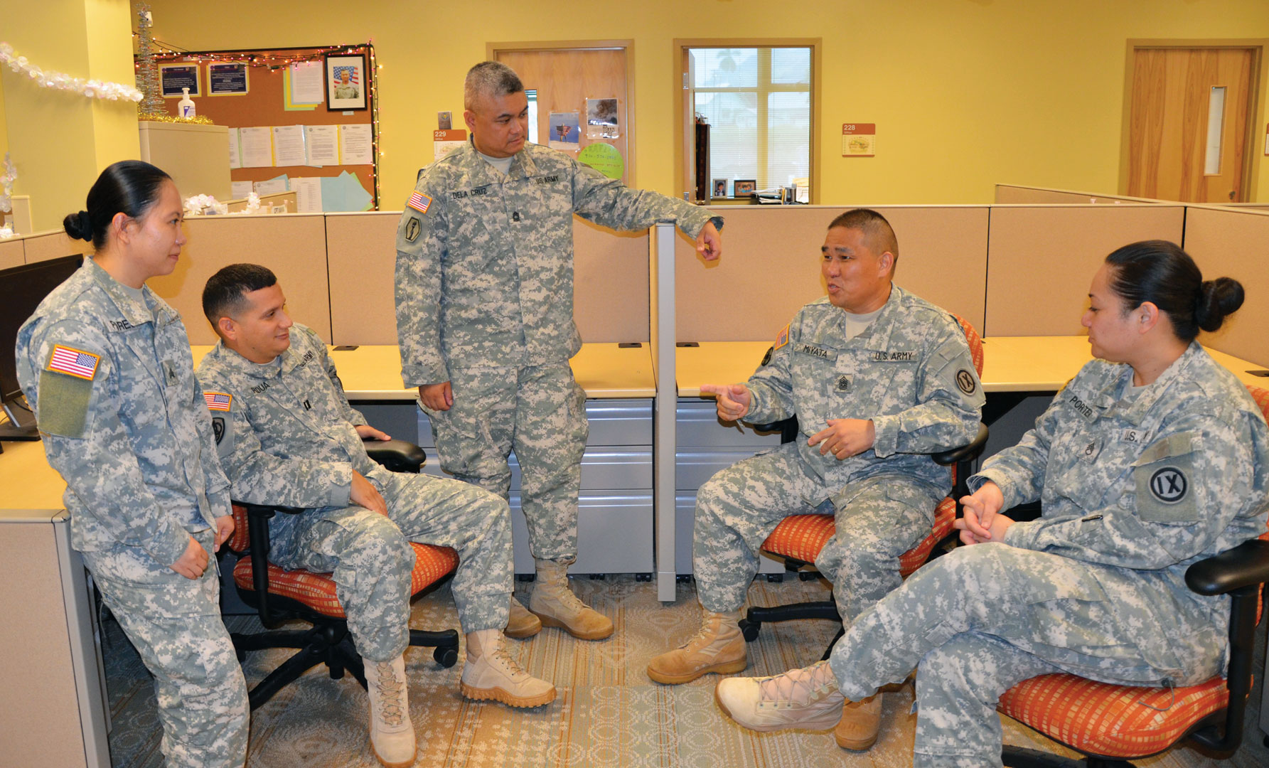 Command Sgt. Maj. John K. Miyata (seated center right) speaks with members of the 3302nd Mobilization Support Battalion’s staff in their offices at Fort Shafter, Hawaii. (Photo courtesy of Command Sgt. Maj. John K. Miyata)