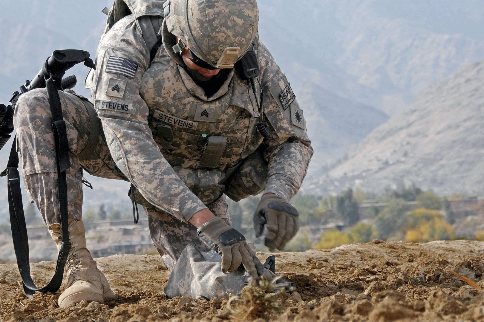 Sgt. Jason Stevens, an agribusiness development horticulturist with the 40th ID, gathers a soil sample in November 2009 from a field in Marawara, Afghanistan. His group met with local farmers about their crop output in the area and gathered soil samples to learn how crop production might be increased in the area. (Photo by Tech Sgt. Brian Boisvert)