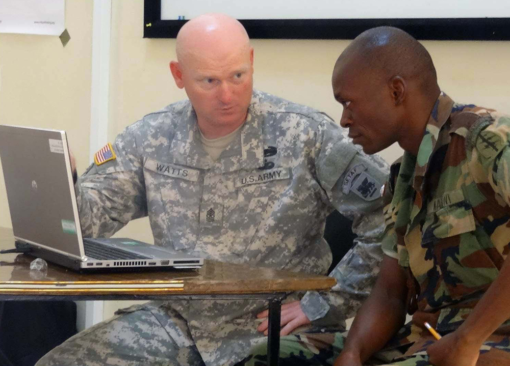 Sgt. Maj. Timothy Watts, one of U.S. Army Africa’s African NCO Education System program managers, works with MDF Master Sgt. Larry Mtimaukanena at the NCO academy in Salima, Malawi. Mtimaukanena is now a student of class 65 at the U.S. Army Sergeants Major Academy at Fort Bliss, Texas. (USARAF photo)