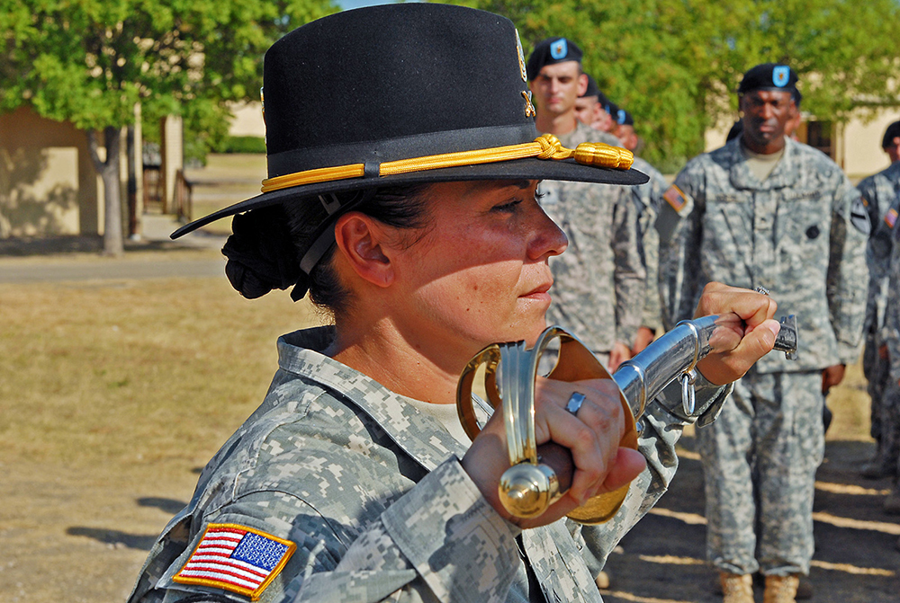First Sgt. Maria Levitre, the senior noncommissioned officer of Headquarters and Headquarters “Hammer” Troop, 1st “Ironhorse” Brigade Combat Team, 1st Cavalry Division, inspects the NCO saber during her change of responsibility ceremony July 12, 2013, at Fort Hood, Texas. (Photo by Staff Sgt. John Couffer)