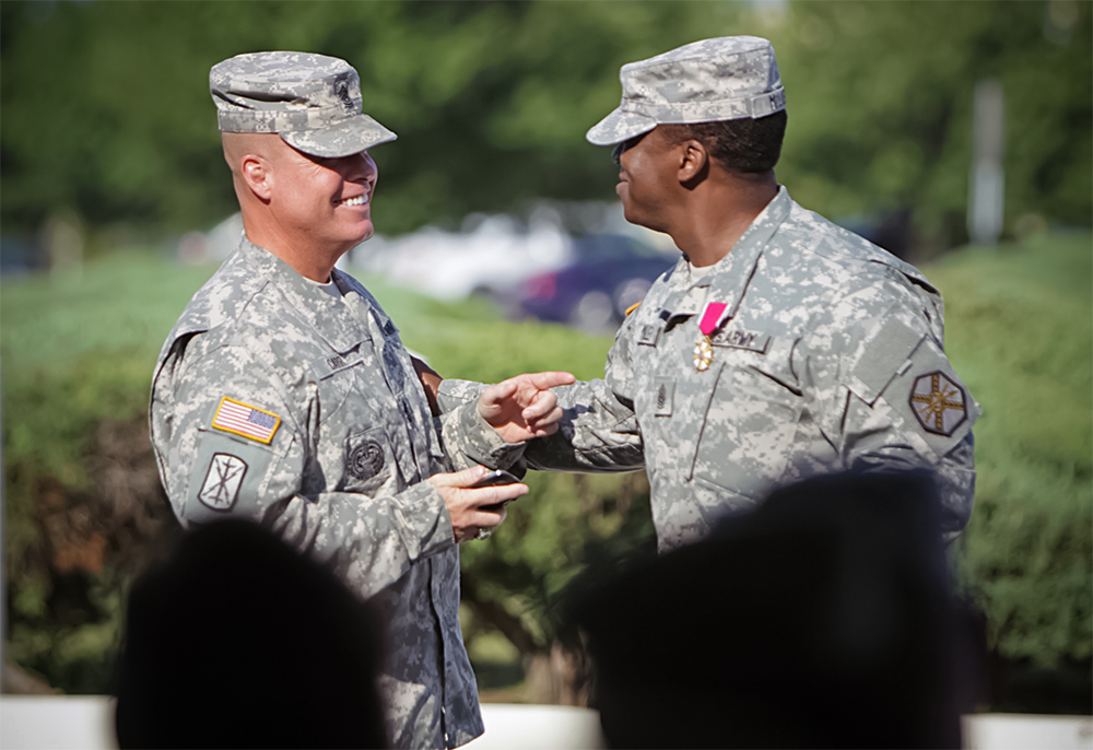Fort Sill’s new garrison command sergeant major, Command Sgt. Maj. David Carr (left) congratulates outgoing Command Sgt. Maj. Thomas Miller after a change of responsibility ceremony Aug. 7 at Fort Sill, Okla. Changes announced this week will alter how the Army considers, selects and slates command sergeants major and sergeants major for Command Select List positions. (Photo by Marie Berberea)