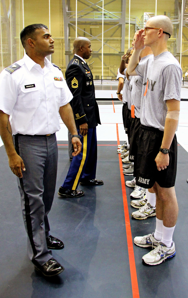 As a West Point cadet (left) leads a lesson teaching new West Point Prep students how to salute correctly, Martin (background) checks for deficiencies. (Photo courtesy U.S. Military Academy)