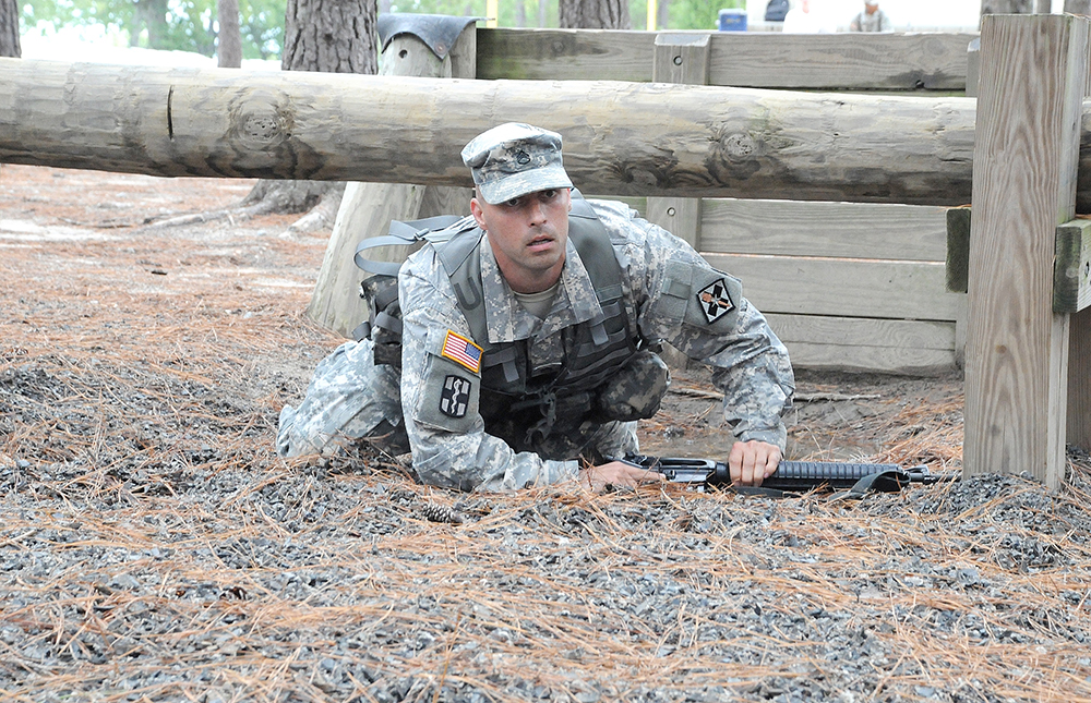 Staff Sgt. Casey Lowe of A Company, 232nd Medical Battalion, 32nd Medical Brigade, at Joint Base San Antonio-Fort Sam Houston, Texas, makes his way through an obstacle course Tuesday. Lowe is competing to be AIT Platoon Sergeant of the Year.