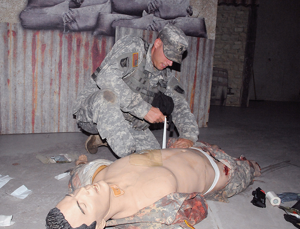 Staff Sgt. Jason Oberle of E Company, 2nd Battalion, 13th Infantry Regiment, at Fort Jackson, S.C., performs first aid during a test Tuesday. Oberle is competing to be Drill Sergeant of the Year.