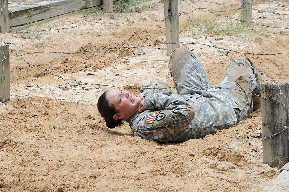 Staff Sgt. Lindsay Hultman, C Battery, 1st Battalion, 434th Field Artillery Brigade, Fort Sill, Okla., backs under the low wire obstacle Wednesday. Hultman is competing to be drill sergeant of the year.