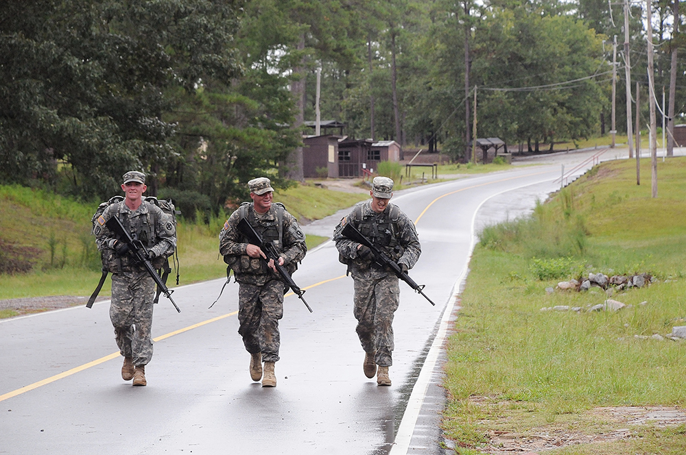 Sgt. 1st Class Thomas Russell, B Battery, 1-78 Field Artillery Battalion, Fort Sill, Okla., (left to right), Staff Sgt. Christopher Croslin, 1st Brigade, 95th Training Division, Norman, Okla., and Staff Sgt. Jonathan Miller, 787th Military Police Battalion, 14th MP Brigade, Fort Leonard Wood., Mo., lead the way during the ruck march on the first day of competition. The trio ended up being the three winners of the competition.