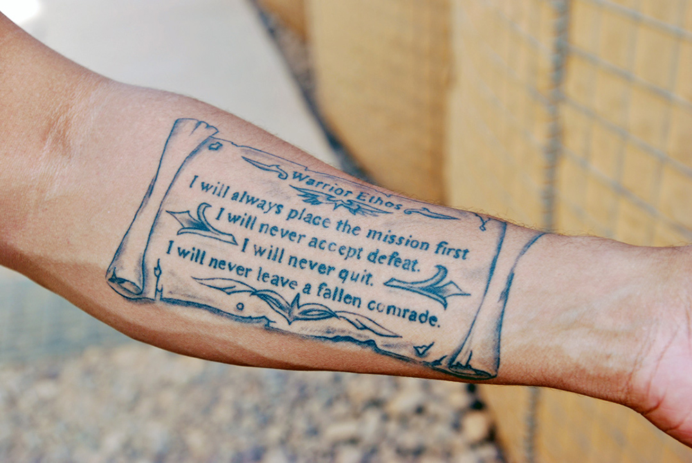 Since it was done several years ago, 1st Sgt. Aki Paylor’s tattoo of the Warrior Ethos is “grandfathered in” under the Army’s new tattoo guidelines, which took effect earlier this year. (Photo by Staff Sgt. Stephanie van Geete)