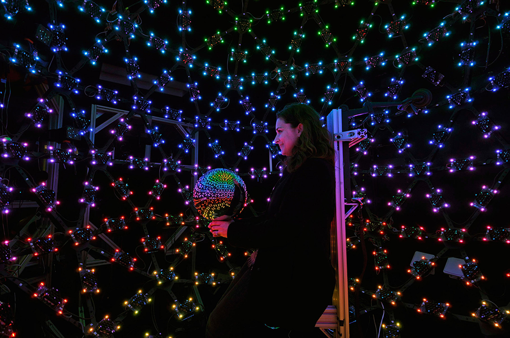 Orli Belman, public relations and programs manager for the Institute for Creative Technologies, holds a mirror ball in the institute’s Light Stage dome. The dome is used for facial scans to help create realistic virtual humans for Hollywood, as well as ICT’s Army projects like ELITE and SimCoach.