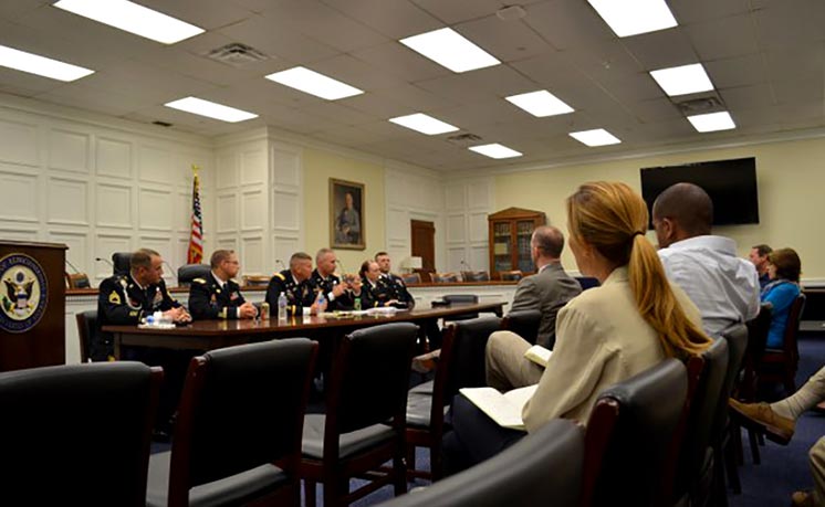 Maj. Joey L. Errington, center right, executive officer of the 2nd Armored Brigade Combat Team, 1st Infantry Division, responds to a question from a congressional staff member in May in the Rayburn House Office Building.