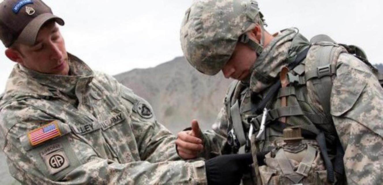 Staff Sgt. Paul Willey, an instructor at the Army’s Northern Warfare Training Center in Alaska, inspects a student’s equipment during the Basic Mountaineering Course.