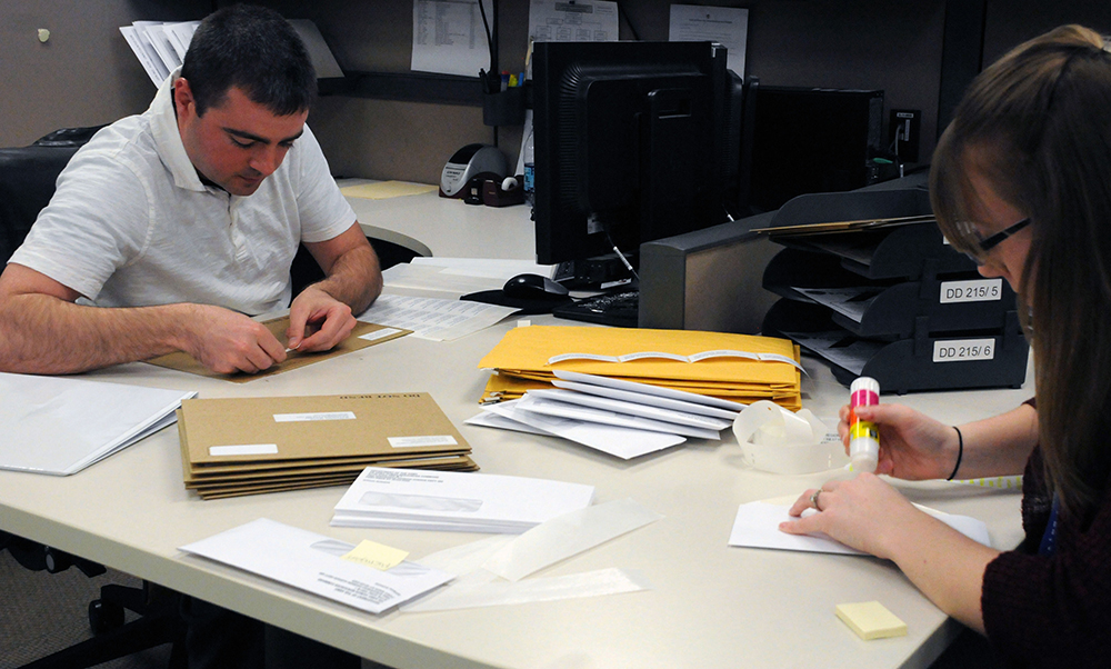Contractors for the Transition Branch at Human Resources Command at Fort Knox, Ky., prepare forms to mail to transitioning Soldiers. (Photo by Martha C. Koester / NCO Journal)