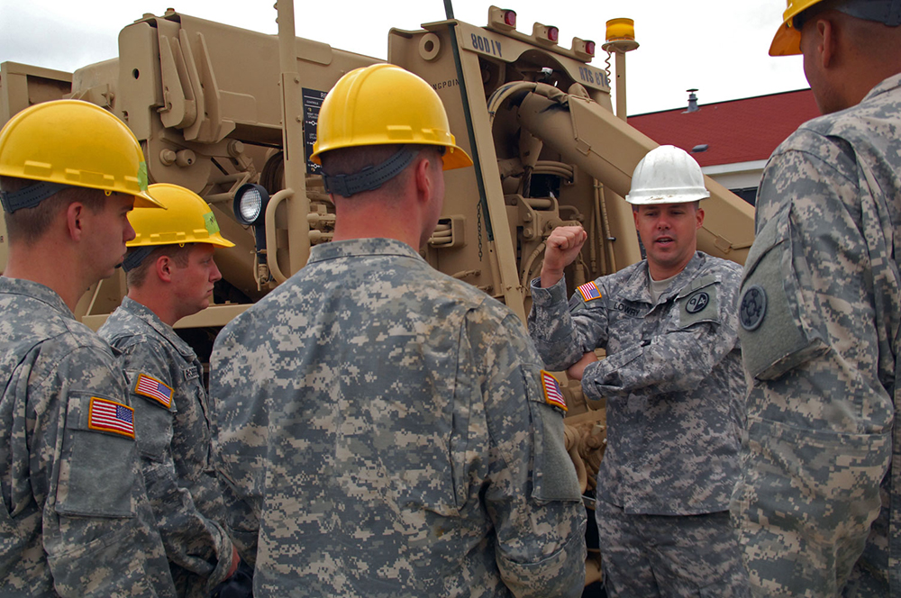 Staff Sgt. Nicholas Lowry instructs students in the operation of a M984 A4 Heavy Expanded Mobility Tactical Truck [HEMTT] at Fort McCoy, Wis. “We’re letting the students get some familiarization with the equipment. Some people have never touched the crane, so we’re getting them some hands-on training,” Lowry said.